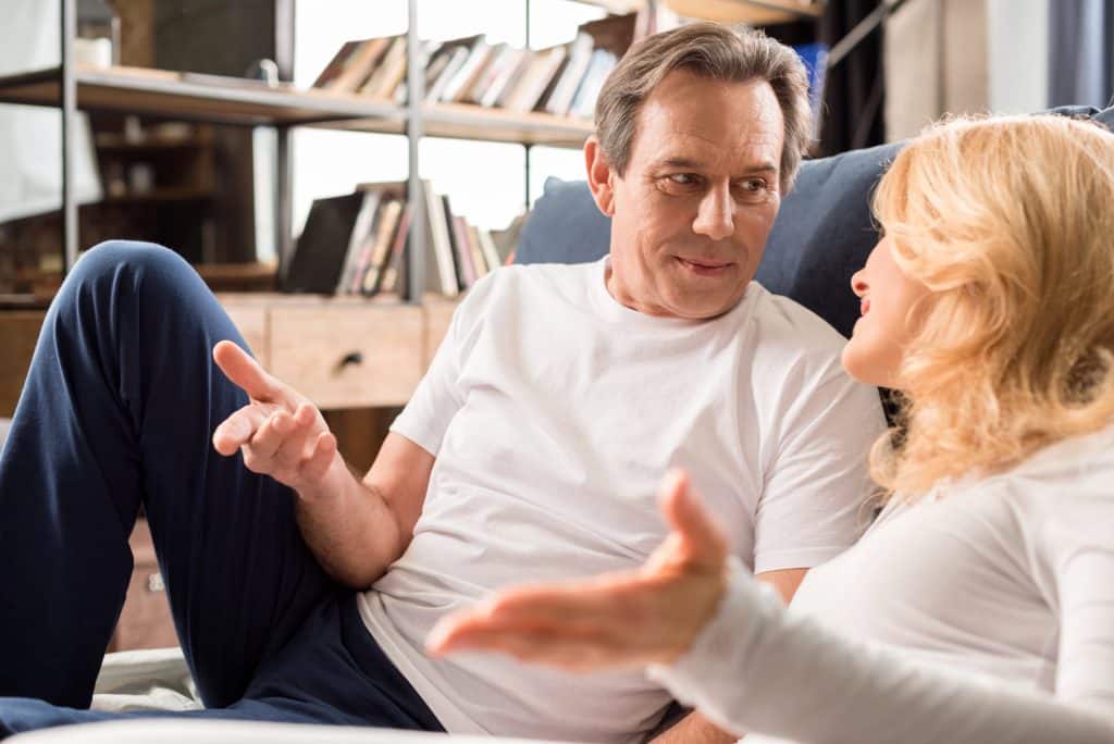 The middle-aged couple is talking at home.