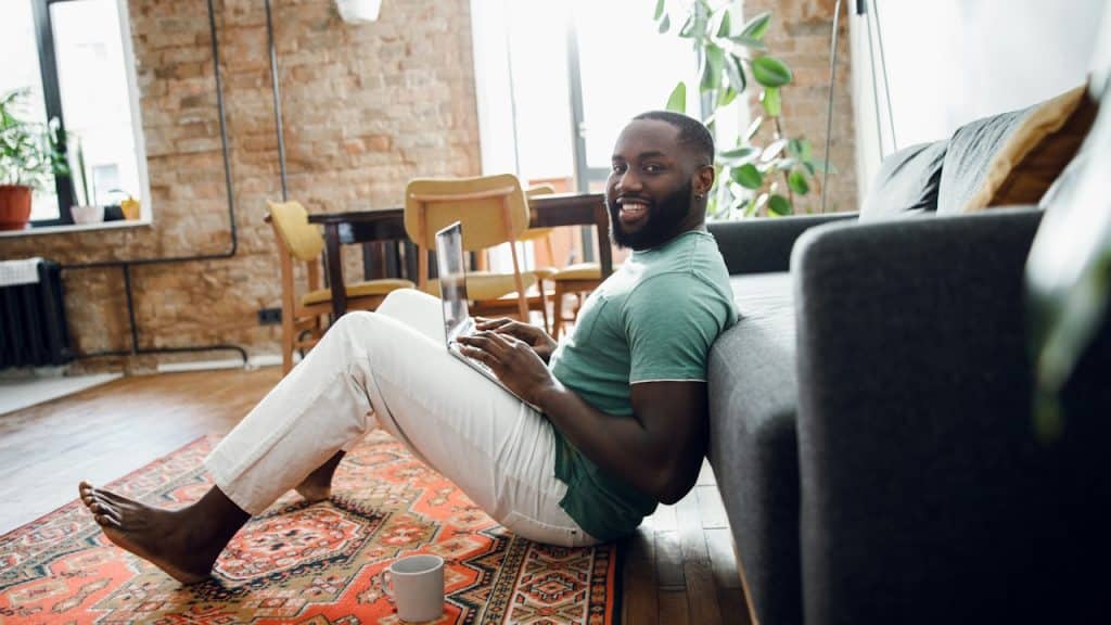 A man using his laptop in his living room.