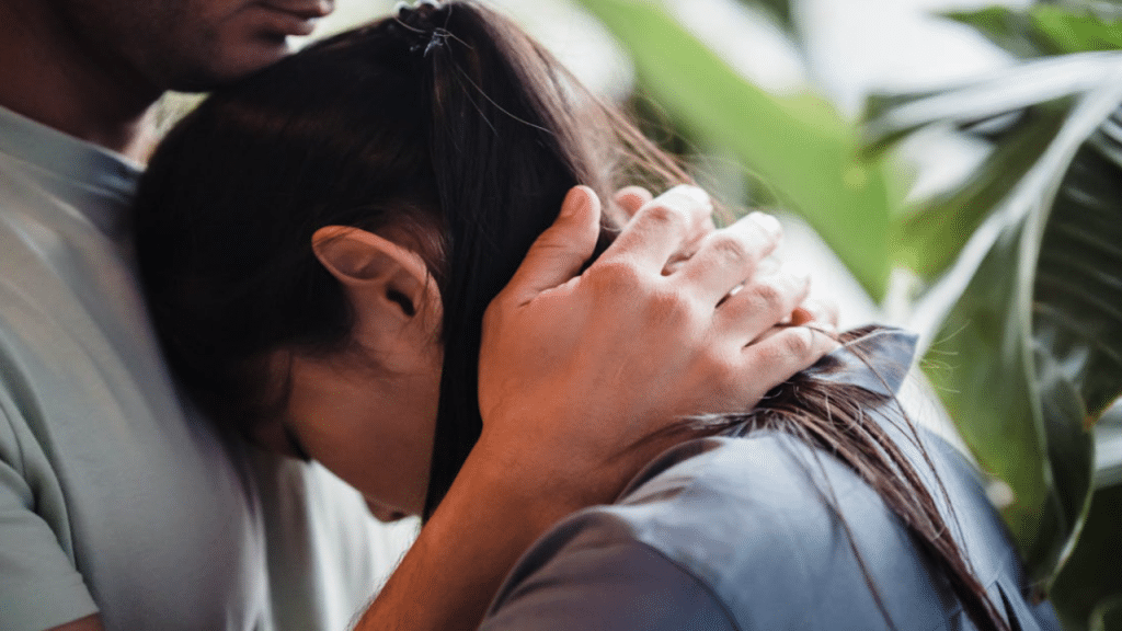 A couple hugging at home