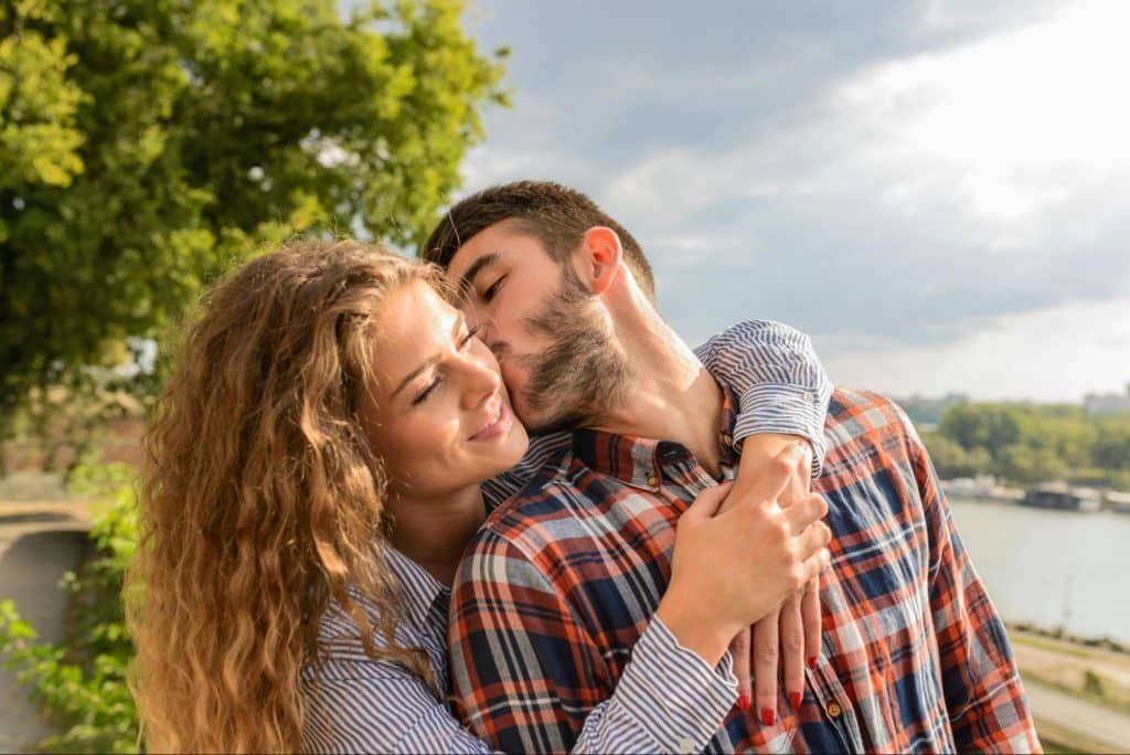 A man kissing a woman’s cheek