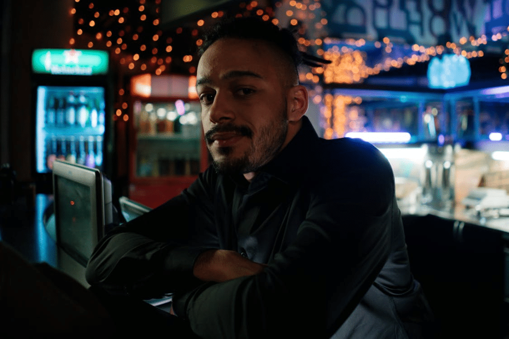 A Man in Black Long Sleeve Shirt Inside a Food Stall