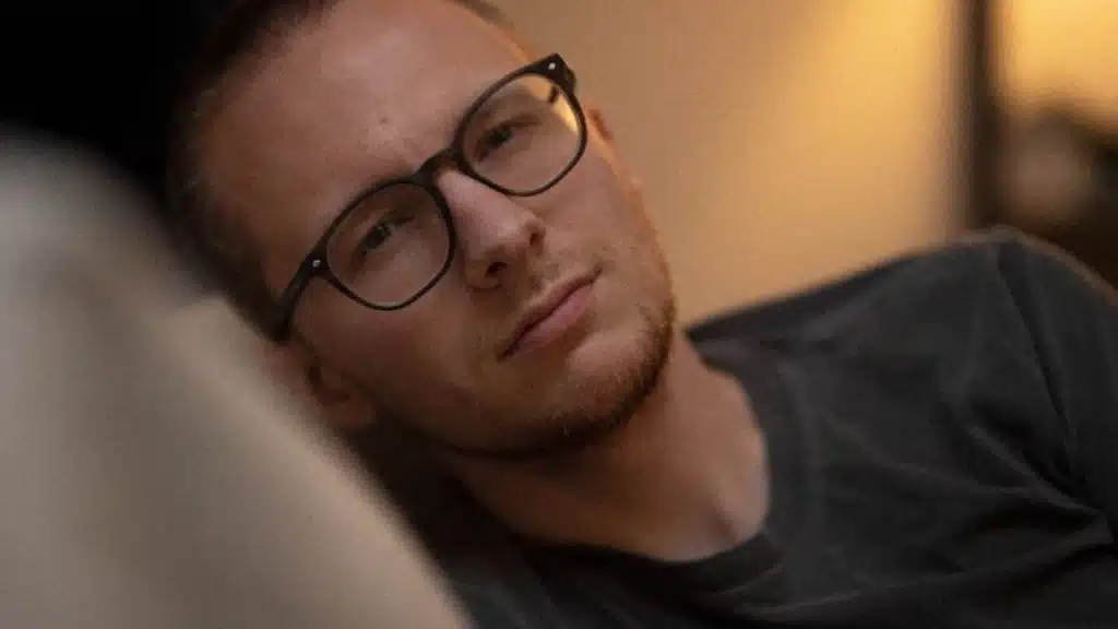 Man reflecting quietly and feeling sad about self improvement