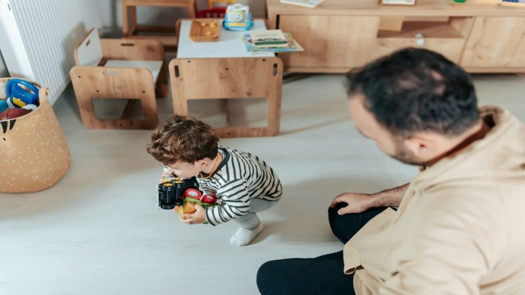 A man taking care of his toddler at home
