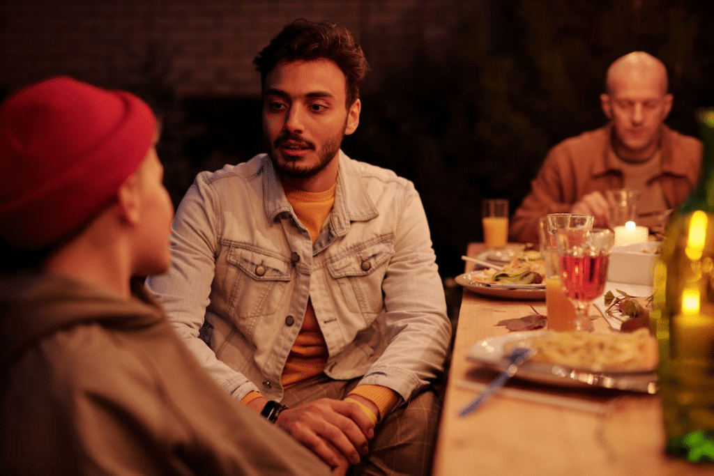 People chatting during evening dinner in backyard