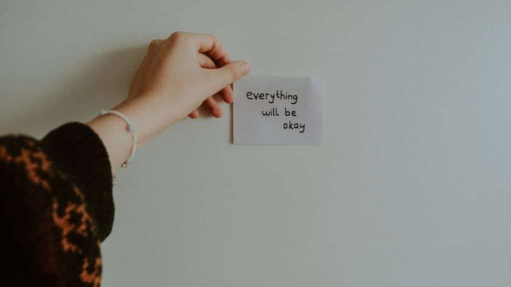 A woman leaving a love note on the fridge
