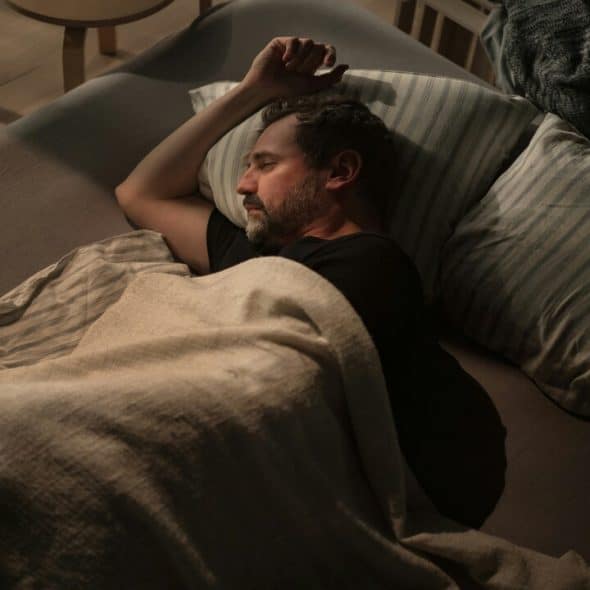 A man looking depressed in bed