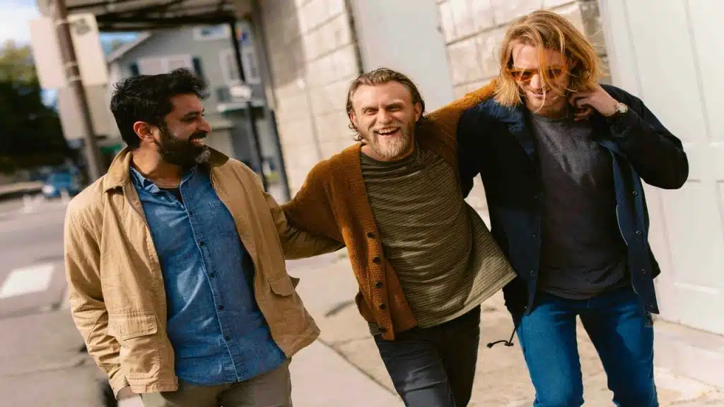 Male friends walking down a street