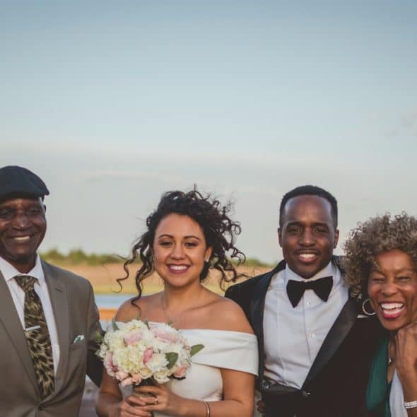 A wedding photo with the groom’s parents.
