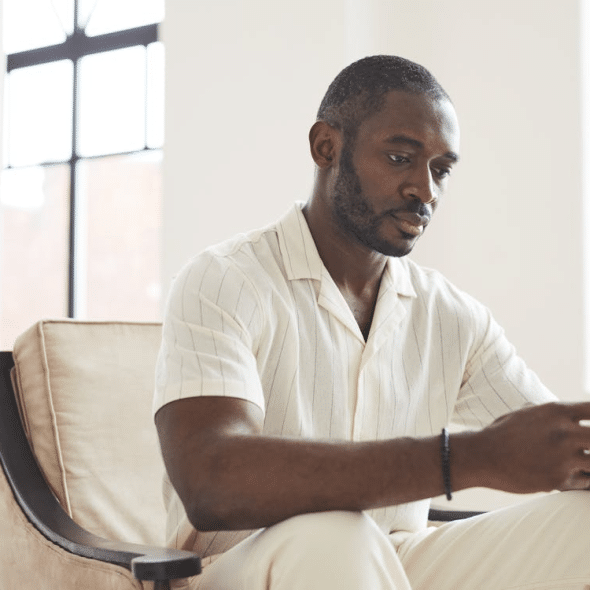 A Man Using a Cellphone while Sitting