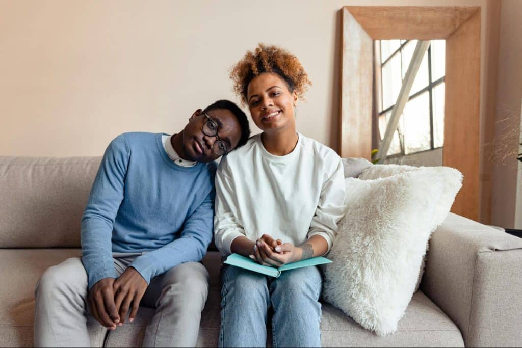 A man and woman sitting at the couch