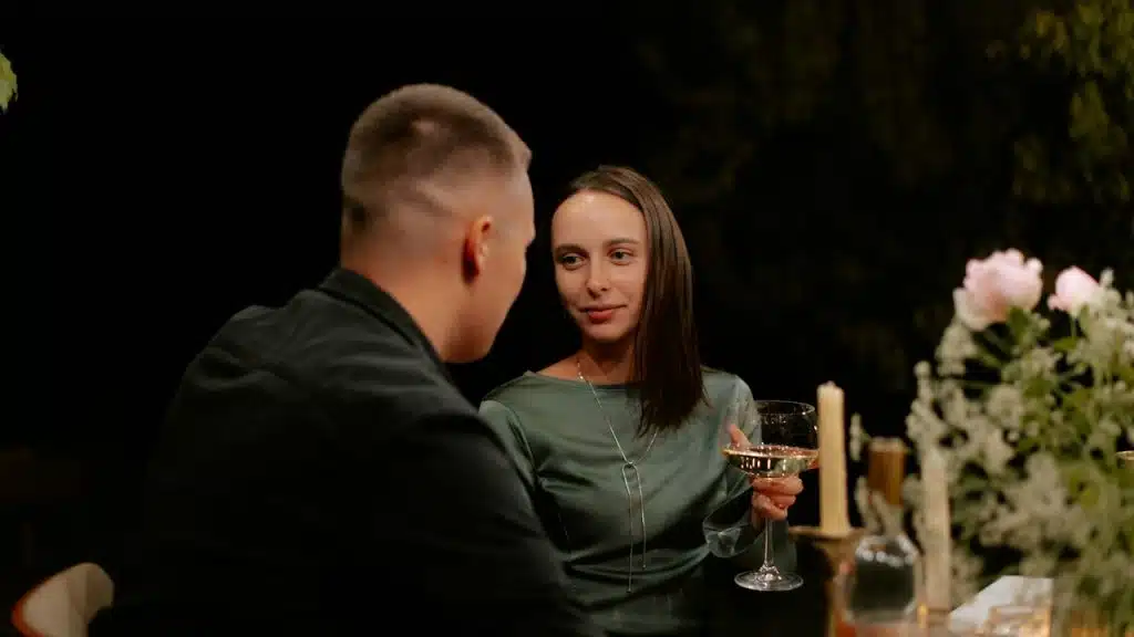 A man and a woman sitting at a dinner table.