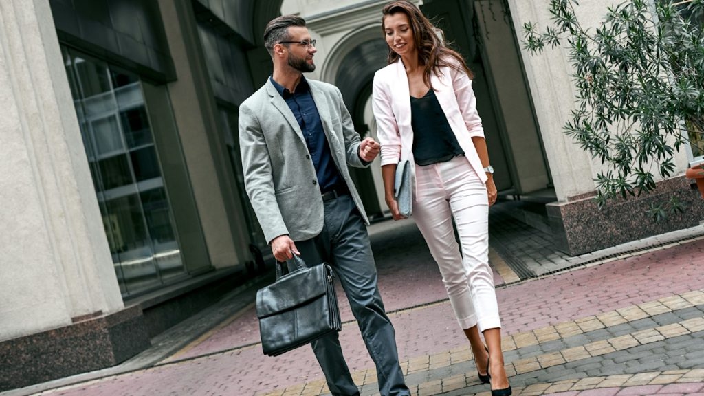 Young businesspeople are walking and discussing a new project.