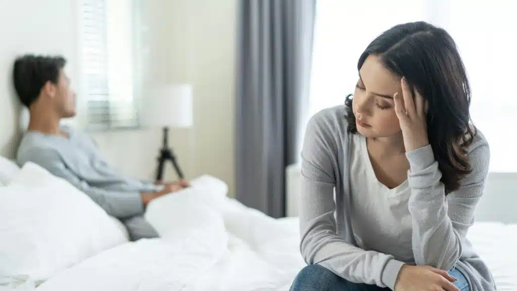 A young couple sitting silent after a fight.