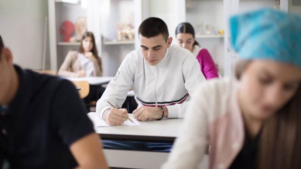 Man attending an evening class, taking notes