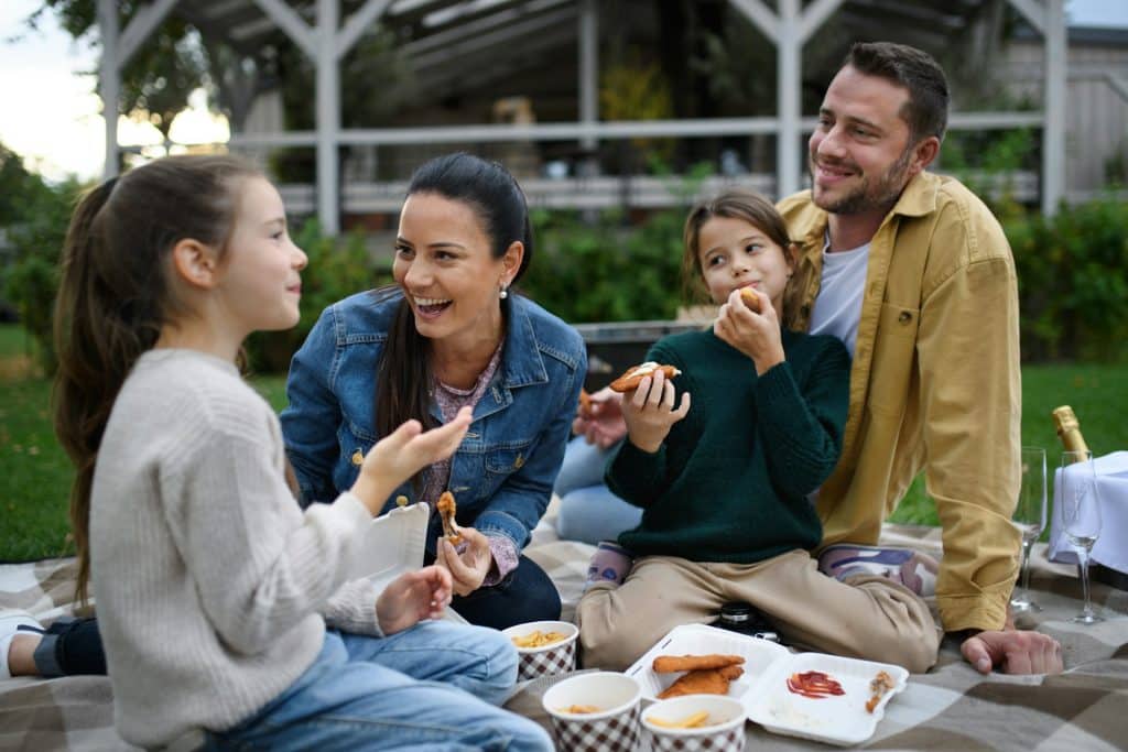 The family is having a picnic outdoors.