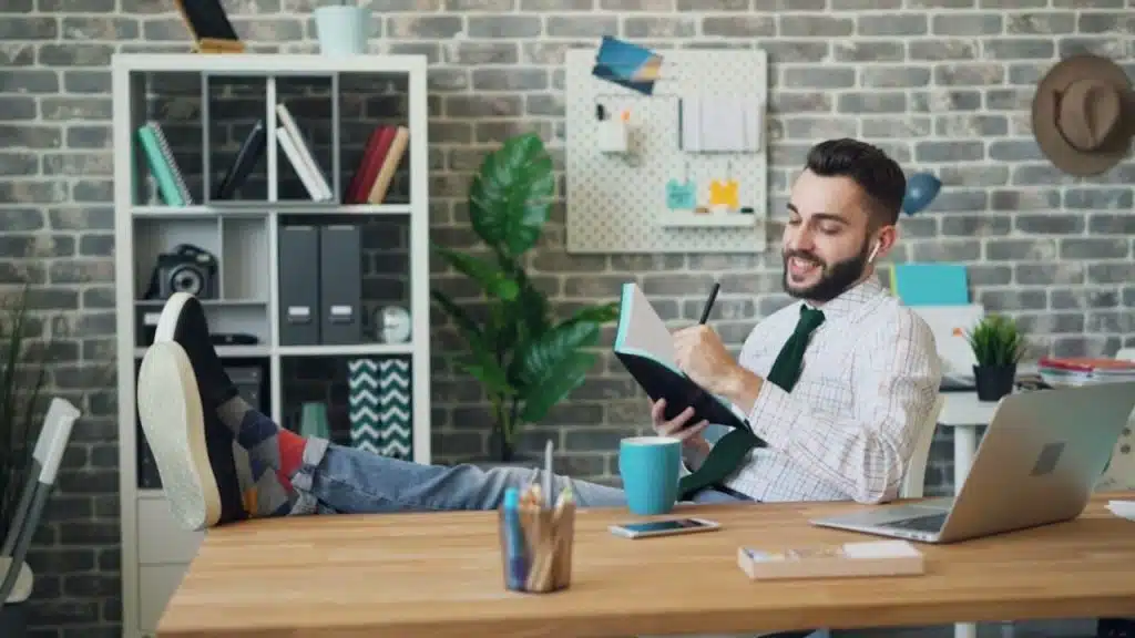 Man in casual clothes journaling with a calm expression