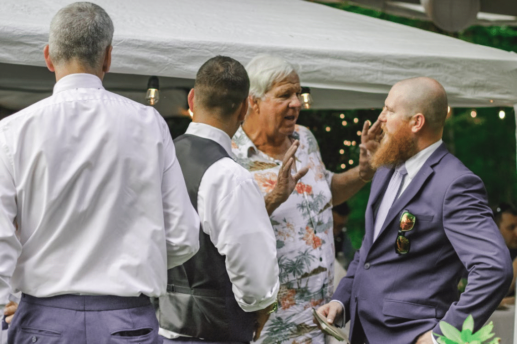 Four Men Standing Near Canopy Tent
