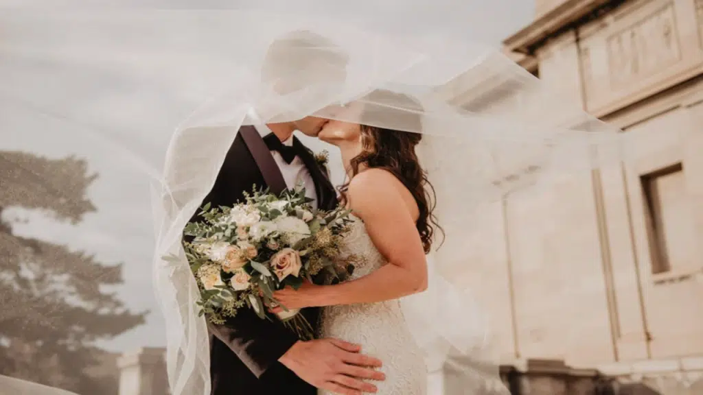 A couple kissing during their wedding