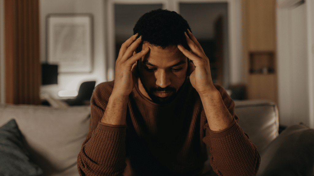A man overthinking at home
