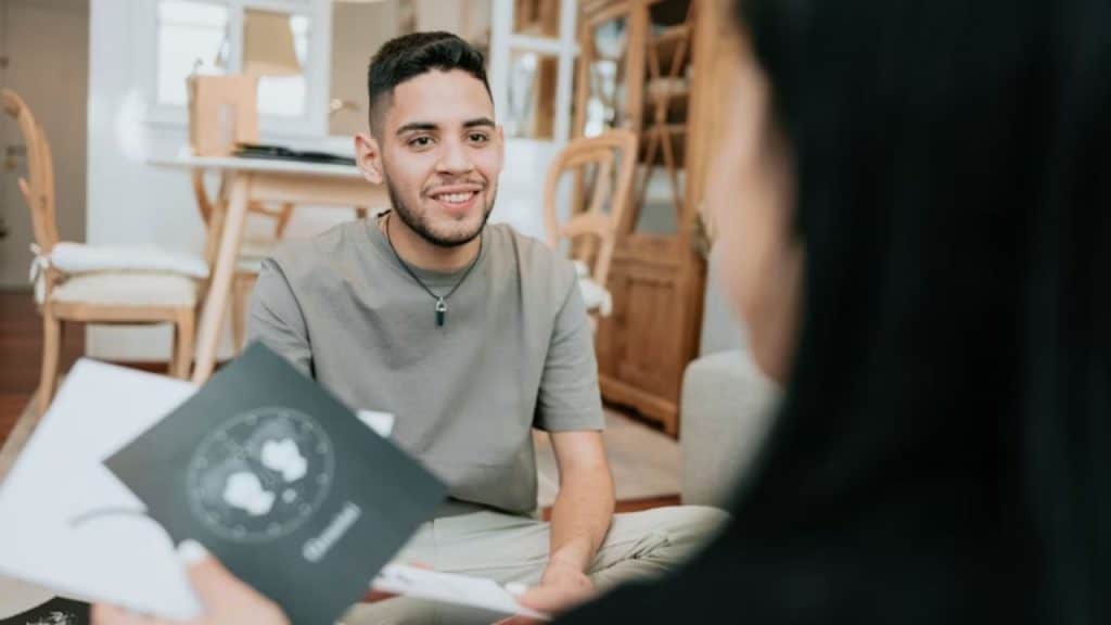 Man smiling calmly during a slightly awkward situation