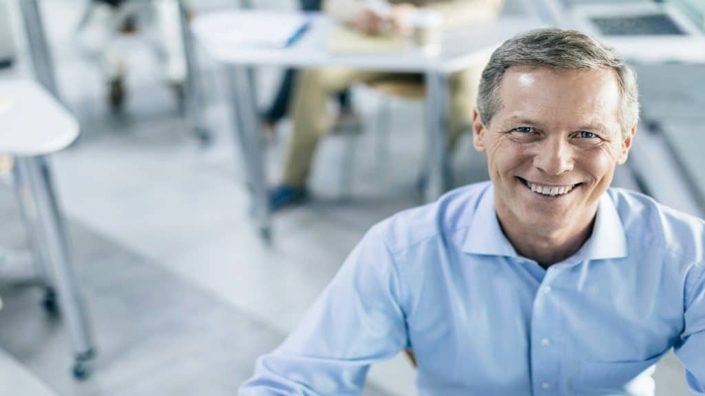 A man smiling at the office