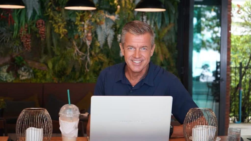 Mature man smiling while setting up an online dating profile