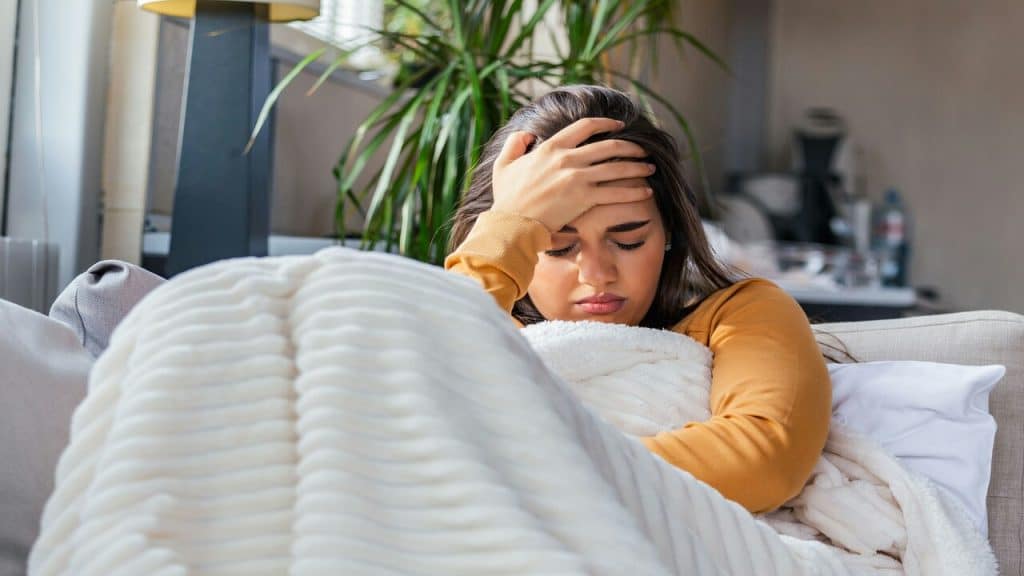 A woman sick on the couch