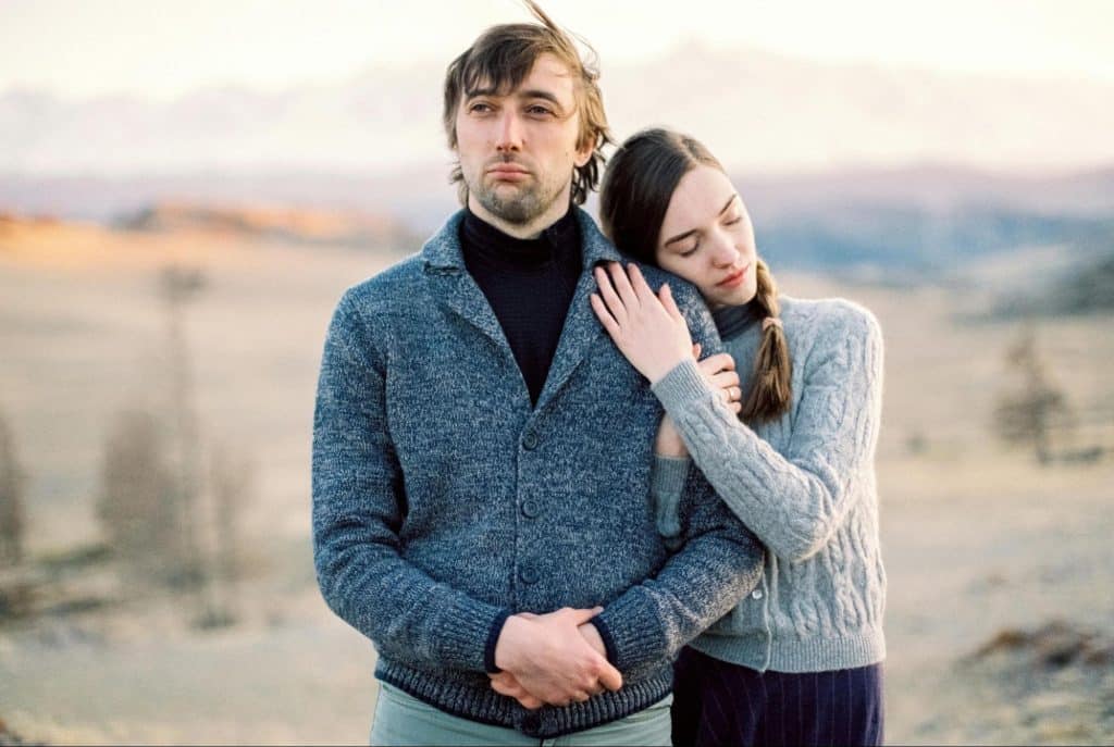A woman leaning on a man’s shoulder