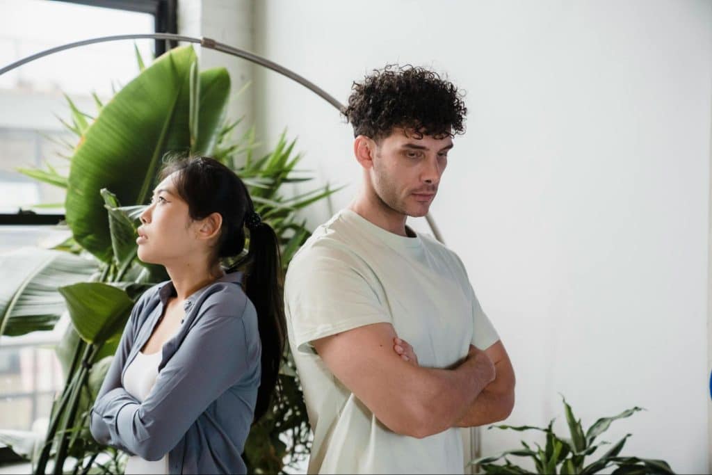 A man and woman standing and not talking to each other 