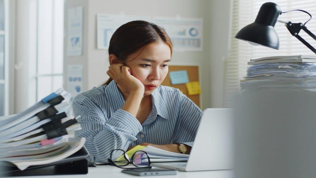 A woman looking stressed at work