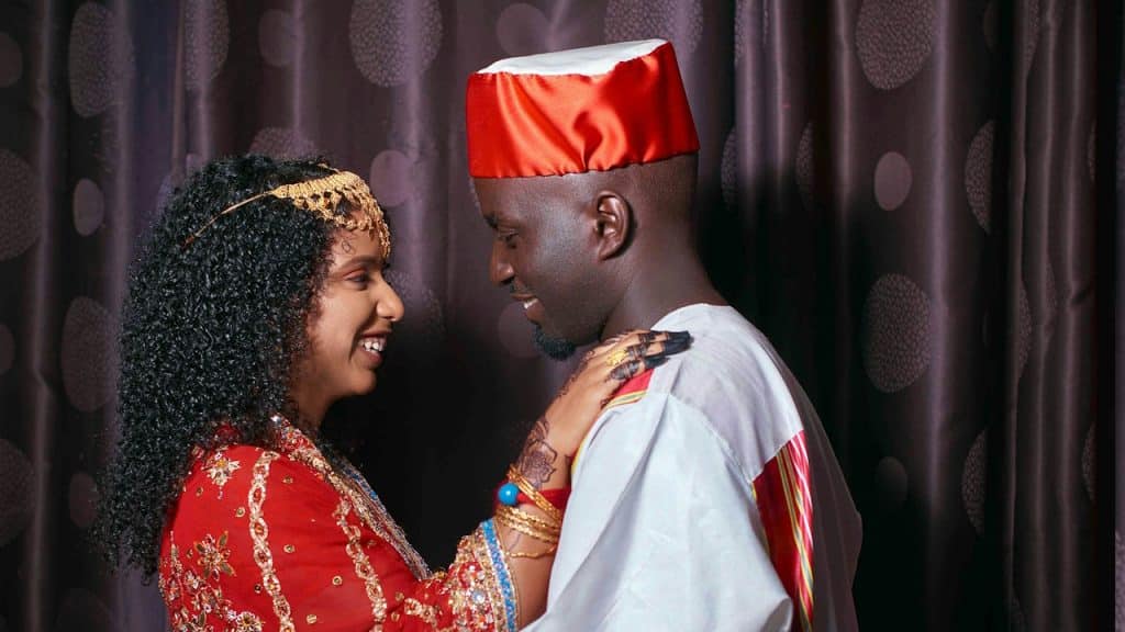 A Black man and an Indian woman in traditional Indian attire.