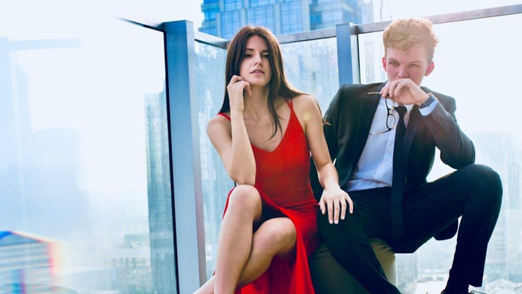 A man and a woman in formal dress sitting together.