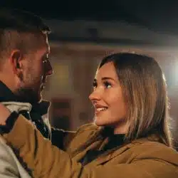 A happy couple embracing and gazing into each other's eyes.