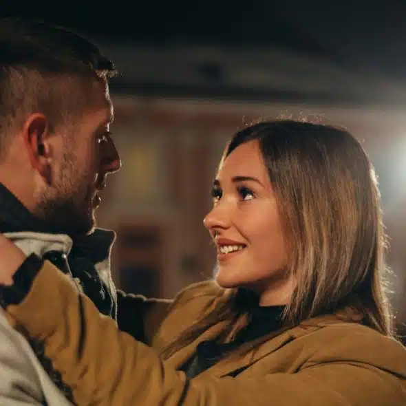 A happy couple embracing and gazing into each other's eyes.