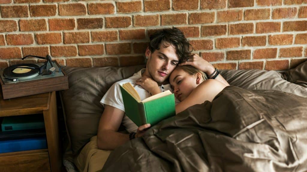 A couple spending time together in bed.