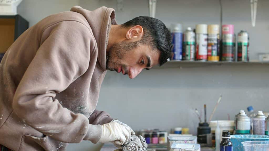 A man working on a piece of art.