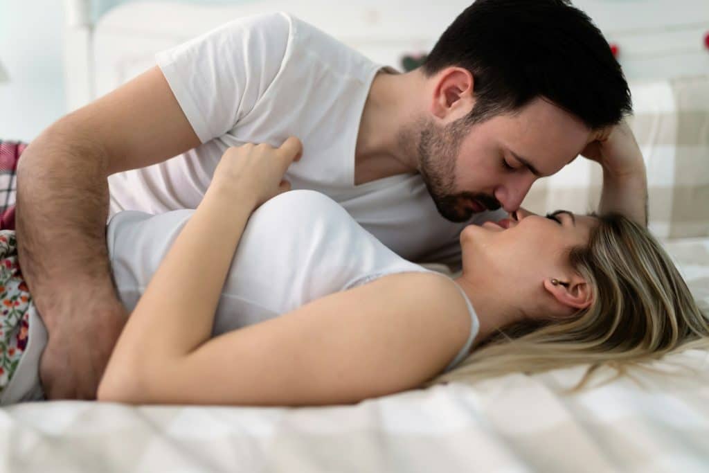 The couple is having a romantic time in bed.