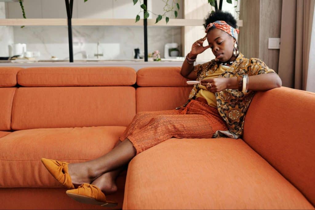 A woman alone sitting at the couch