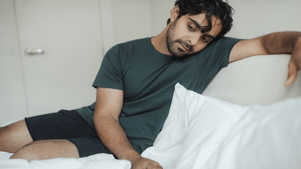 A man looking upset in the bedroom
