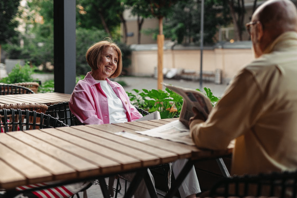 Woman and Man Sitting at Wooden Table