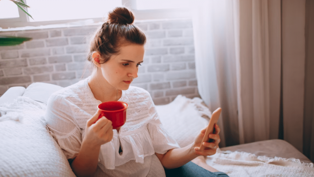 A woman looking sadly at her phone