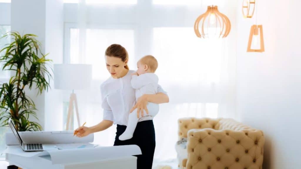 A responsible woman looking at the graphic while taking care of her baby