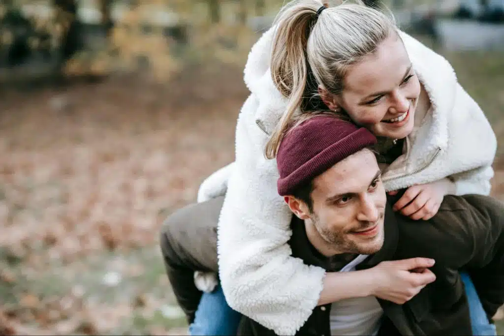 A man carrying a woman on his back