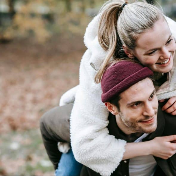 A man carrying a woman on his back