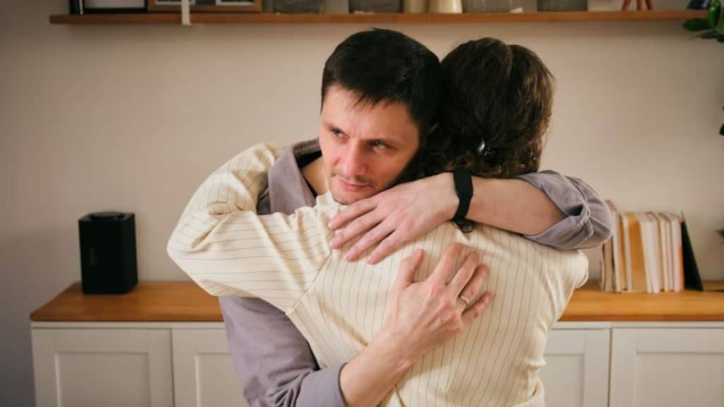 Man comforting his partner during an emotional moment