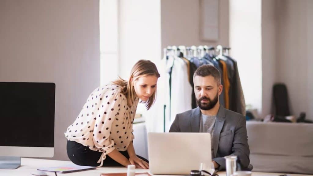Couple reviewing household tasks on a laptop together