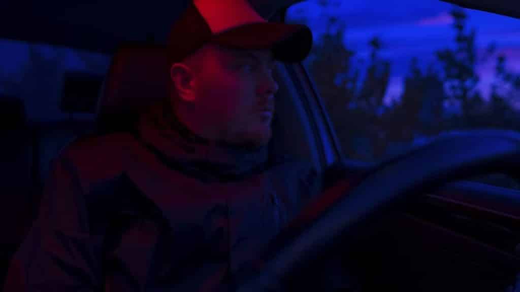 Man sitting in his car at night deep in thought