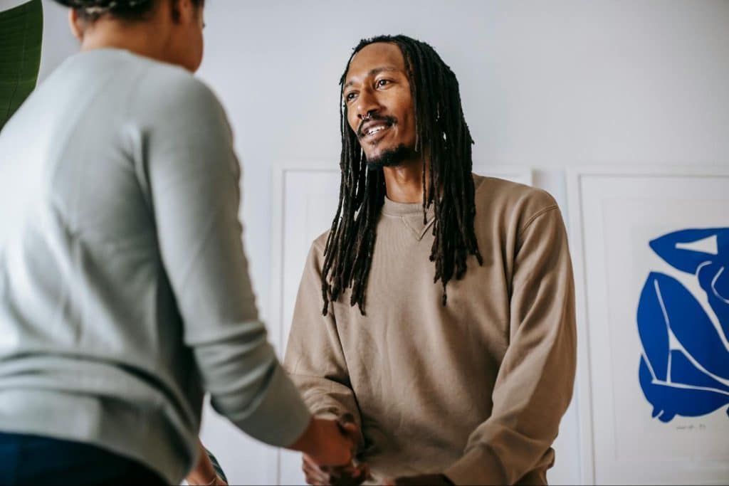 A man smiling at the woman