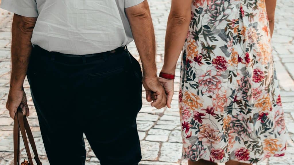 An old couple holding hands.
