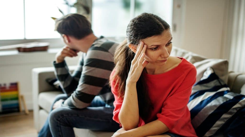 Unhappy spouses looking away from each other.